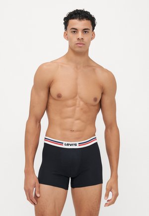 Schwarze Boxershorts mit einem weißen Bund, der rote und blaue Streifen aufweist, aus weichem Stoff, gestaltet für Komfort und Passform.