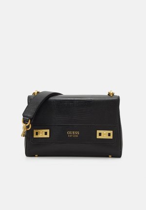 Sac à main Guess en cuir noir texturé avec ferrures dorées, une large bandoulière et un logo gravé à l'avant.