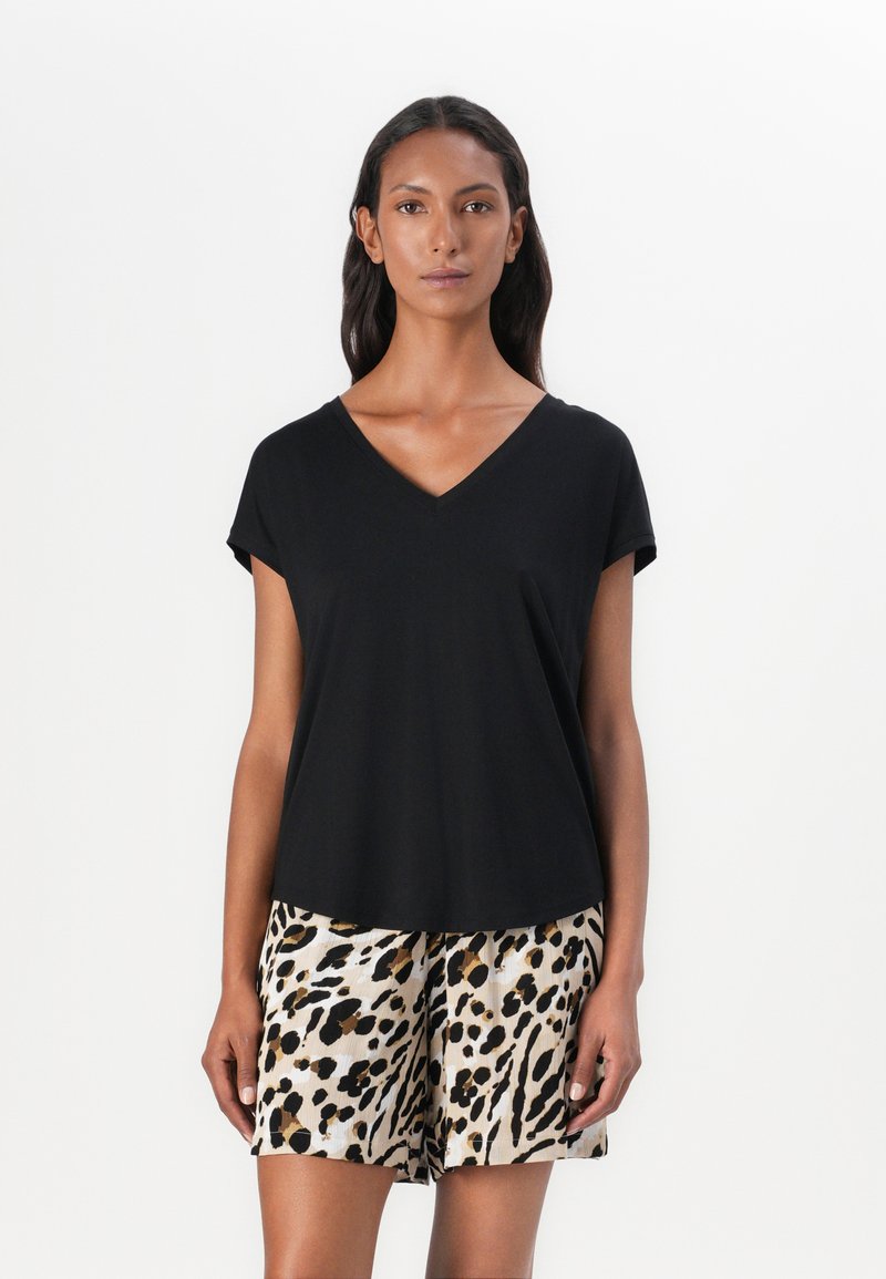 Black V-neck t-shirt with short sleeves paired with knee-length shorts featuring a beige and black leopard print pattern. Smooth texture.