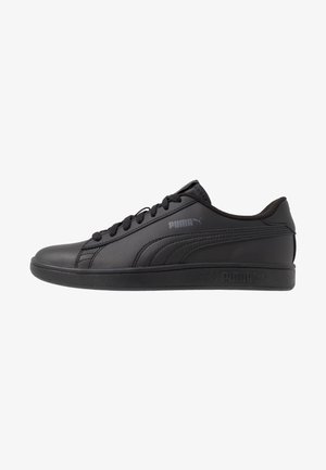 Black leather sneaker with a smooth surface, round toe, flat rubber sole, and branded accents. Features thick laces and a low-top design.
