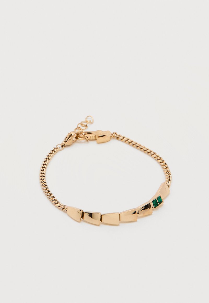 Βραχιόλι αλυσίδας από χρυσό με γεωμετρικούς πλάκες και δύο μικρές πράσινες ορθογώνιες πέτρες σε λευκό φόντο.