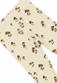 Leggings i en cremet farve med et gentaget svampeprint, der viser forskellige svampeformer og nuancer. Blødt, strækbart stof.