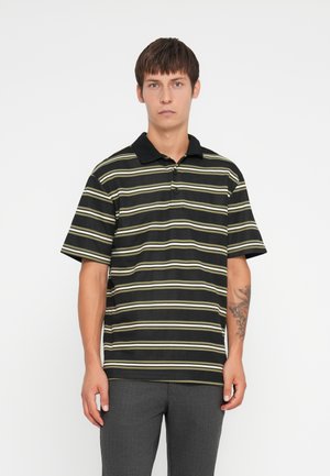 Black and striped polo shirt with short sleeves, featuring horizontal green and white stripes, and a black collar.