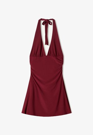 Burgundy halter dress with a deep V-neckline, gathered waist, and flowing skirt. Soft fabric with a smooth texture and adjustable tie.