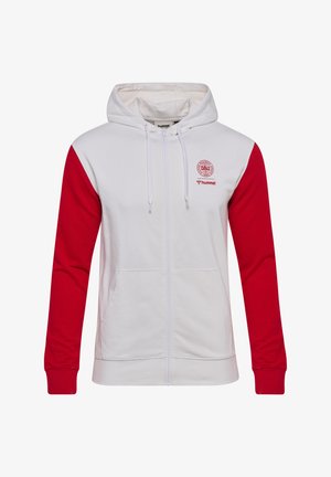 Biała bluza z kapturem na zamek, z czerwonymi rękawami, przednimi kieszeniami, sznurkiem w kapturze oraz czerwonymi logo DBU i hummel na lewej piersi.