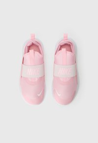 Pár ružových Nike slip-on tenisiek s elastickými páskami a bielymi podrážkami, zobrazených zhora na obyčajnom bielom pozadí.