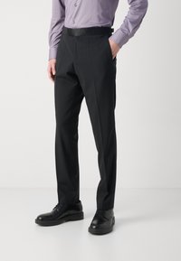 Black trousers with a tailored fit, smooth fabric, and side pockets. Paired with black dress shoes and a light purple button-up shirt.