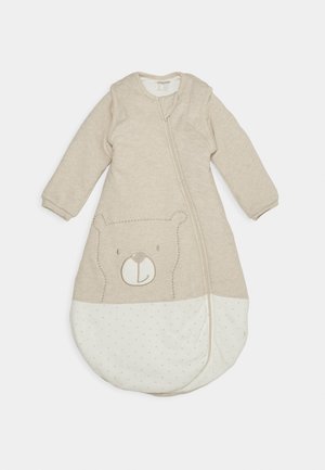 Beige sleeping bag with long sleeves, featuring a bear design and polka dot pattern on the lower half; zip closure along the front.