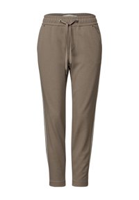 Lichtbruine sweatpants met een elastische tailleband en trekkoord, voorzien van zijstrepen en twee zakken. Gemaakt van zachte stof, met een taps toelopende pijp.