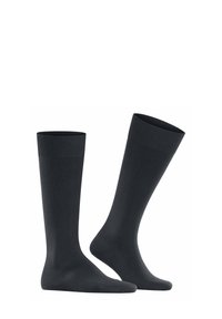 Calze nere al ginocchio con parte superiore a coste e una texture liscia. Progettate per comfort e durata, adatte a diverse occasioni.