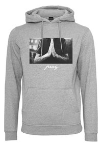 Gray hoodie with a front pocket, featuring a black-and-white photo of hands in a prayer position and the word "pray" in white script below.
