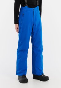 Modré nepremokavé lyžiarske nohavice s nastaviteľnými popruhmi, so zipsom uzatváranými vreckami a voľným strihom. Vyrobené z hladkej, odolnej látky s vystuženými manžetami.