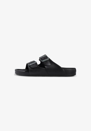 Schwarze Sandalen mit zwei verstellbaren Schnallen, aus strukturiertem synthetischem Material, mit flacher Sohle und offenem Zehendesign.