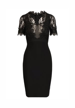 Robe noire longueur genou avec manches courtes en dentelle transparente, encolure en dentelle florale et silhouette ajustée.