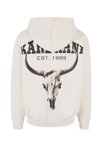Hooded sweatshirt in off-white with a large black bull skull graphic on the back, featuring bold text "KARDANI EST. 1989" above.