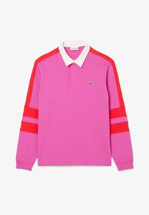 Roza majica s dolgimi rokavi polo, ki ima rdeče črte na rokavih in belo ovratnico. Vključuje majhen zeleni znak na prsih.