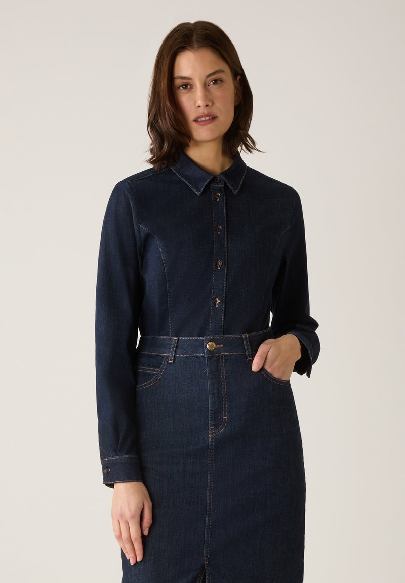 Dark blue denim dress with a collared neckline, button closure, long sleeves, and a belted waist; features light stitching accents.