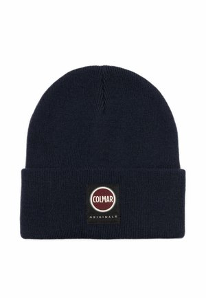 Navy blue knitted beanie with a fold-over cuff, featuring a round black and red Colmar Originals logo patch on the front.