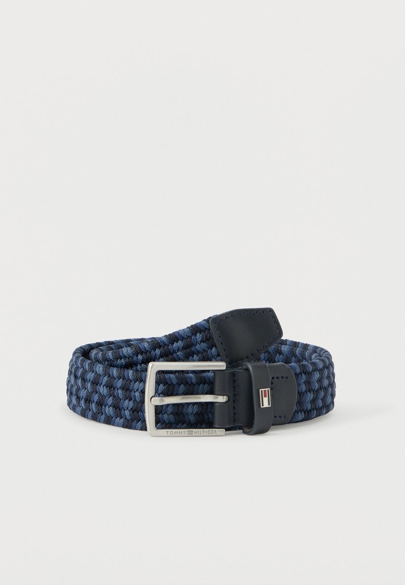 Blue and black woven fabric belt with silver rectangular buckle and black leather accents, including a small flag emblem.