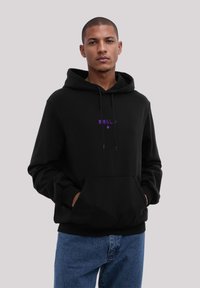Sudadera con capucha negra y bolsillo canguro frontal, texto morado y gráfico de estrella. Fabricada con tejido suave, con puños y dobladillo acanalados.