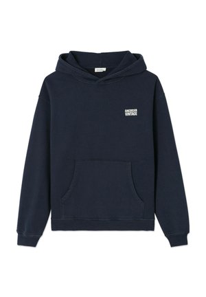 Sweat à capuche bleu marine avec poche avant et logo blanc "American Vintage" sur la poitrine gauche, présenté sur fond blanc.