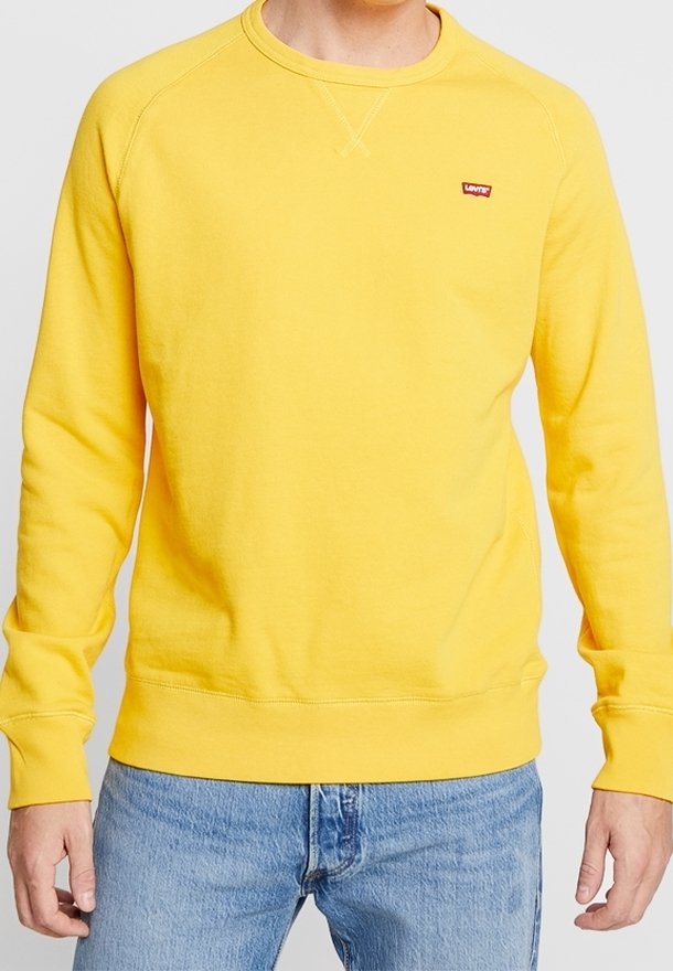 Sweatshirt jaune à col rond en coton, avec des poignets et un ourlet côtelés, agrémenté d'un petit logo rouge sur la poitrine.