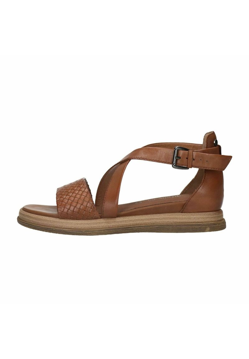 Brown leather sandal with woven texture on toe strap, adjustable ankle strap, and flat, light-colored rubber sole.