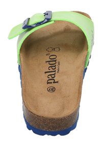 Green and blue slide sandal with adjustable strap, cork footbed, and textured sole. Branding visible on the inner insole.