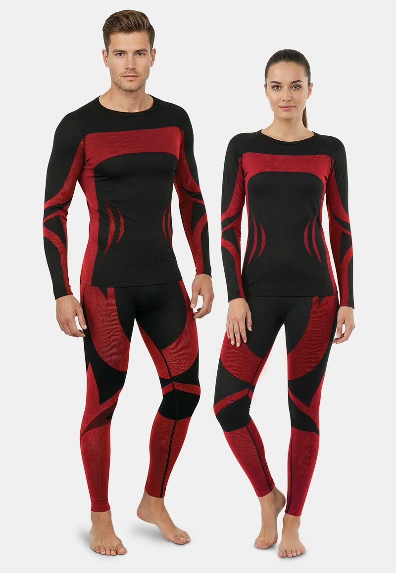 Black athletic tops and leggings with red abstract patterns. The fabric appears textured with long sleeves and fitted design.
