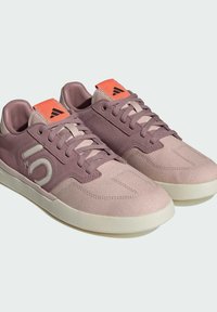 Sneaker in camoscio e tessuto rosa e lavanda con suole beige, caratterizzati da una finitura testurizzata, chiusura con lacci e un'etichetta di accentuazione arancione.