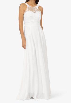 Biała wieczorowa suknia z przezroczystym, haftowanym gorsetem, szerokimi ramiączkami i zwiewną, sięgającą do podłogi spódnicą. Delikatne kwiatowe zdobienia na całej powierzchni.