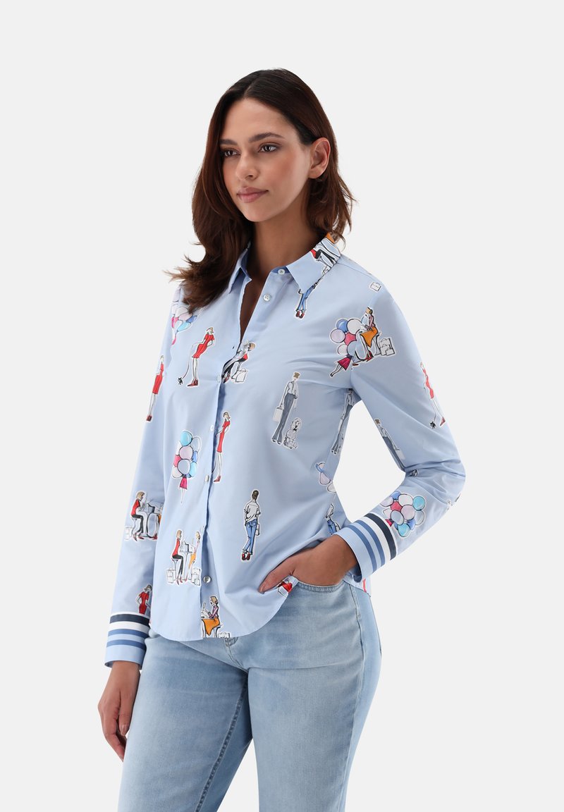 Light blue button-up shirt with colorful fashion illustrations. Features a collar, long sleeves, and striped cuffs. Made from smooth fabric.