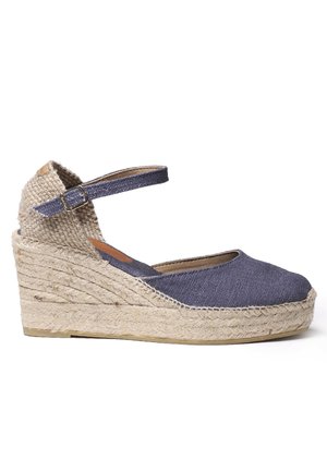 Wedge espadrille sandal featuring a dark blue canvas upper, natural jute rope midsole, and an ankle strap with metal buckle detail.