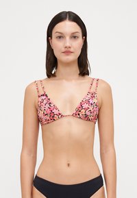 Floral triangle bikini top in black with pink and yellow flower patterns; thin adjustable straps; gathered fabric; minimal coverage design.
