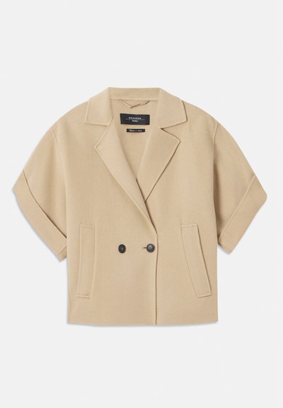 Beige double-breasted jacket with short sleeves, featuring a notched lapel and two front pockets, made from a soft textured fabric.