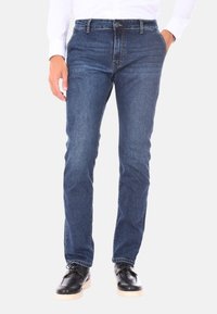 Jeans in denim blu scuro con design a gamba dritta, presentano una chiusura con zip, cinque tasche e dettagli di cucitura in contrasto.