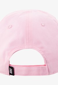 Boné de beisebol rosa feito de algodão com aba curvada, fita ajustável na parte de trás e pequenos buracos de ventilação. Apresenta uma etiqueta de logotipo preta.