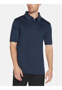 Marineblaue Polo-Hemd mit kurzen Ärmeln aus glattem Stoff. Verfügt über einen Kragen, eine Dreiknopf-Leiste und ein dezentes Logo auf der Brust.