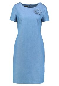 Farkkutunika vaaleansinisessä värissä, jossa on pyöreä kaula-aukko ja lyhyet hihat. Vasemmalla puolella koristeellinen kankaasta tehty kukka.