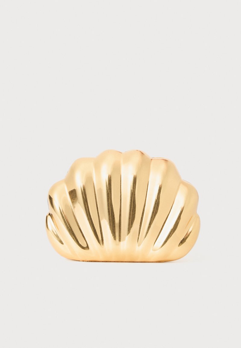 Gold shell-shaped hair clip with ridged texture; glossy finish highlights curves and folds. Compact design suitable for securing hair.