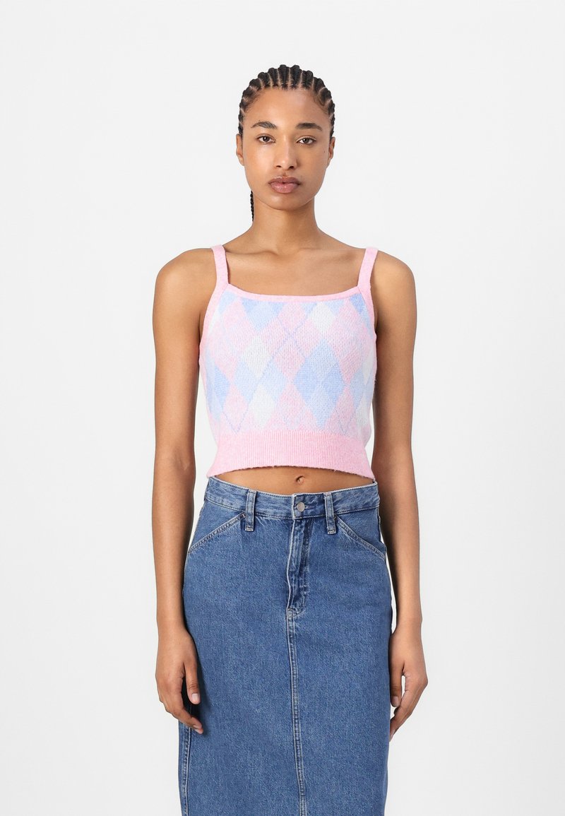 Pink and blue argyle knit crop top with thin straps, paired with a high-waisted denim skirt. Texture is soft, with visible ribbed hem.