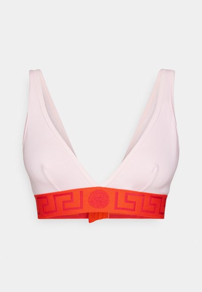 Light pink bralette with a deep V-neck, featuring a bold red band with a geometric pattern. Made from a smooth, stretchy material.