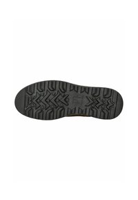 Suela de zapato de goma negra con un patrón de textura, que incluye ranuras multidireccionales y formas angulares para mejorar el agarre y la durabilidad.