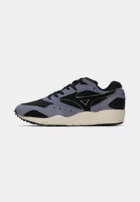 Παπούτσι τύπου sneaker με κορδόνια που διαθέτει συνδυασμό μαύρων και μοβ υλικών, αερίσια στοιχεία και υφή στην σόλα. Σημαντική πράσινη λεπτομέρεια λογότυπου στο πλάι.