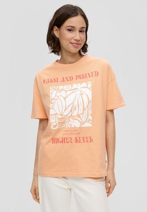 Peach cotton t-shirt with oversized fit, featuring white graphic design and red text reading "CALM AND RELAXED" and "HIGHER LEVEL."