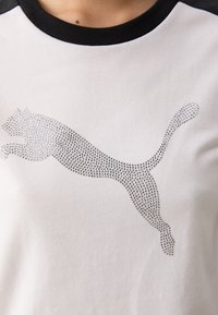 Black and white t-shirt featuring a sparkling silver Puma logo on the front, displaying a leaping cat design.