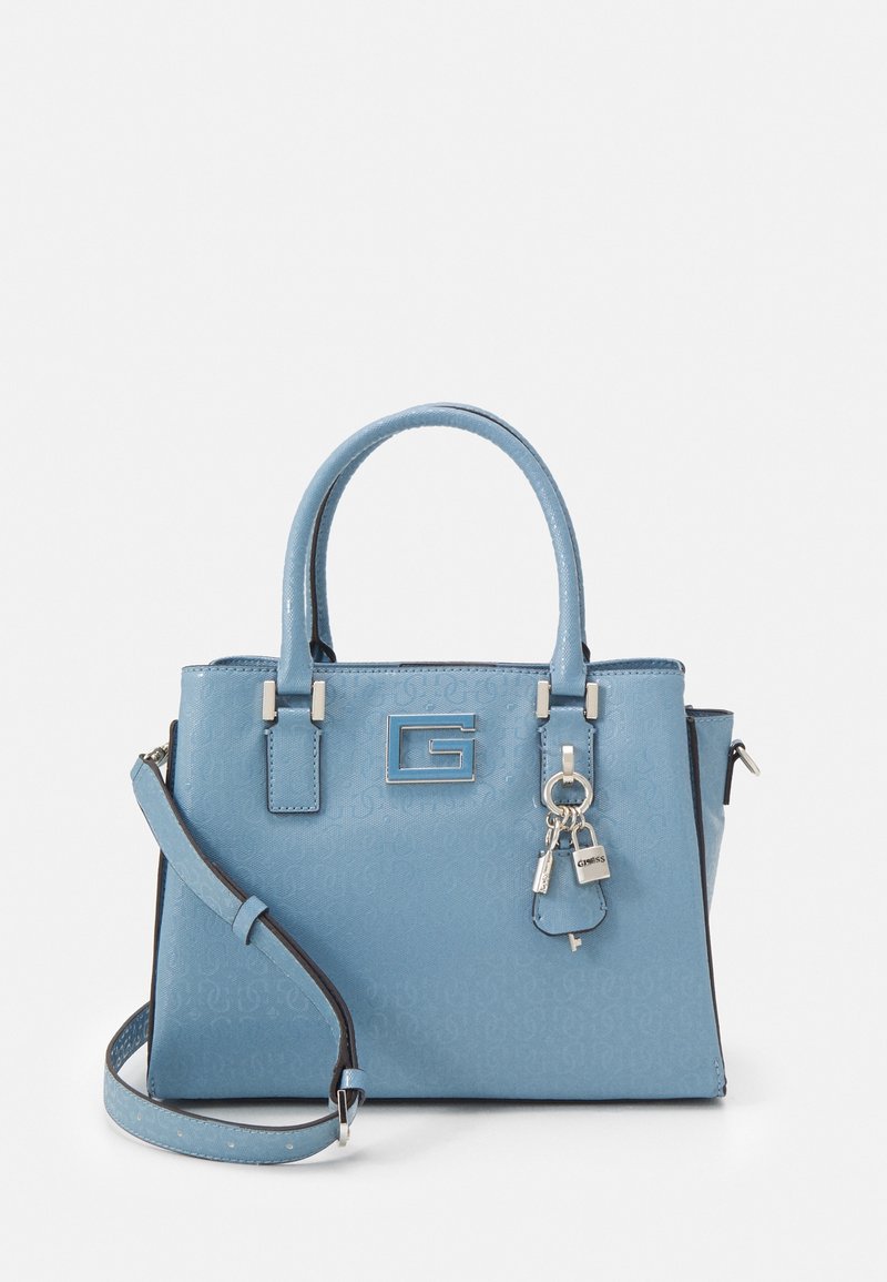 Sac à main bleu clair avec doubles poignées, bandoulière réglable, logo G argenté, et porte-clés avec cadenas attaché à l'avant.
