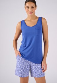 Blauwe tanktop met gegolfde rand en zak, gecombineerd met witte shorts met blauwe bladerenpatronen. Glad textuur, casual ontwerp.