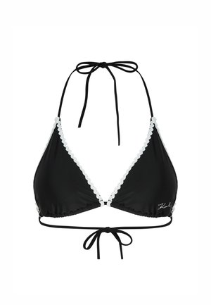 Črn bikini zgornji del s trikotnimi skodelicami, belimi valovitimi robovi, vratnimi vezalkami in nastavljivim vezanjem na hrbtu. Narejen je iz gladkega, elastičnega materiala.