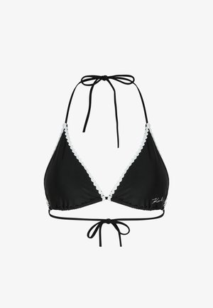 Črn bikini zgornji del s trikotnimi skodelicami, belimi valovitimi robovi, vratnimi vezalkami in nastavljivim vezanjem na hrbtu. Narejen je iz gladkega, elastičnega materiala.